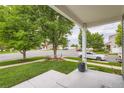 View from the front porch looking at the landscaped front yard and quiet neighborhood street at 5570 Nepal St, Denver, CO 80249