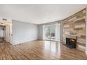 Spacious living room showcasing wood floors, fireplace, and a sliding glass door for natural light at 12191 Melody Dr # 301, Westminster, CO 80234