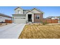 Inviting two-story home featuring a well-manicured lawn, a two-car garage, and an American flag displayed at 11783 Niagara St, Thornton, CO 80233