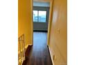 Hallway with wood-look flooring and a view of the window at 8643 Carr Loop, Westminster, CO 80005