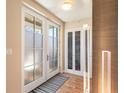 Modern entryway with a hardwood floor, double doors, and sleek lighting at 410 Acoma St # Brownstone 3, Denver, CO 80204