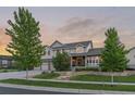 Charming two-story home with a three-car garage, beautiful landscaping, and inviting curb appeal at 27290 E Nova Cir, Aurora, CO 80016