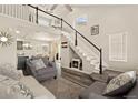 Spacious living room with vaulted ceilings, fireplace, and open view to dining area at 11816 Zenobia Loop, Westminster, CO 80031