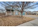 Two-story home with blue siding and two-car garage on a corner lot with a mature tree at 2080 S Danube Ct, Aurora, CO 80013