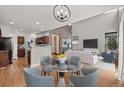 Bright living space with hardwood floors seamlessly flows into a dining area and kitchen at 2080 S Danube Ct, Aurora, CO 80013