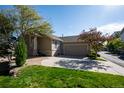 Lovely single-story home featuring a well-maintained lawn, a two-car garage, and mature trees at 9567 Brentwood Way # A, Broomfield, CO 80021