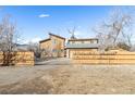 A fenced yard with a large garage and home, creating a private outdoor space at 2541 Yarmouth Ave, Boulder, CO 80301