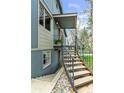 Side view of home showcasing updated exterior, metal railing, and easy access to the front entrance at 505 S Roosevelt Rd, Lafayette, CO 80026