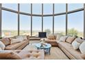 Bright and airy living room featuring walls of windows with panoramic views at 1175 Ridge Oaks Dr, Castle Rock, CO 80104