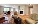 Cozy living room with hardwood floors, a fireplace, and comfortable seating arrangements at 18073 E Belleview Pl, Centennial, CO 80015