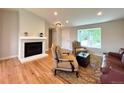Bright living room with fireplace, neutral walls, and hardwood floors at 18073 E Belleview Pl, Centennial, CO 80015