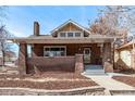 Inviting brick home with craftsman-style features, a gabled roof, and a welcoming front porch at 1601 Jackson St, Denver, CO 80206