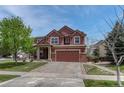Charming two-story home featuring a two-car garage, well-manicured lawn, and inviting front porch at 22965 Allendale Ave, Parker, CO 80138