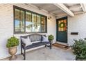 Cozy front porch featuring a bench, plants, and a charming green front door with wreath at 5965 S Gaylord Way, Greenwood Village, CO 80121