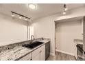 Modern kitchen featuring granite countertops and stainless steel appliances at 2880 S Locust St # 704N, Denver, CO 80222