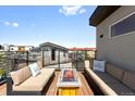 Inviting roof deck with comfortable seating around a modern fire pit, offering a relaxing outdoor space at 2804 W 53Rd Ave, Denver, CO 80221