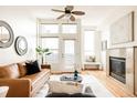 Bright and airy living room boasts a fireplace, hardwood floors and large windows at 2680 Blake St # 12, Denver, CO 80205