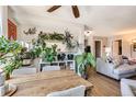 Bright dining area features a wooden table and many decorative plants at 12512 E Cornell Ave # 304, Aurora, CO 80014