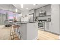 Modern kitchen featuring stainless steel appliances, a breakfast bar, and bright natural light at 891 14Th St # 2914, Denver, CO 80202