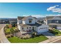 Charming two-story home with a welcoming front porch and manicured landscaping at 11269 Star Streak Rd, Littleton, CO 80125