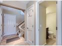 Bright foyer featuring tile flooring, staircase to the second floor, and a view to the half-bath at 1470 S Quebec Way # 46, Denver, CO 80231
