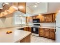 Well-lit kitchen with wood cabinets, modern appliances, and ample counter space, offering a functional design at 1470 S Quebec Way # 46, Denver, CO 80231