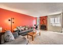 Spacious living room features a cozy fireplace and natural lighting at 1470 S Quebec Way # 46, Denver, CO 80231