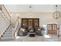 Bright, open foyer featuring large bookshelves and chandelier at 4121 S Allison St, Denver, CO 80235