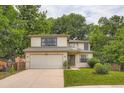 Traditional two-story home featuring a well-maintained lawn and a two-car garage at 912 S Galena St, Aurora, CO 80247