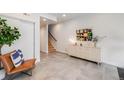 Bright entryway with modern tile flooring, cabinet, and stairs to the next level at 3520 W Conejos Pl # 10, Denver, CO 80204
