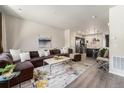 Spacious open-concept layout with a large sectional sofa and seamless flow to the kitchen at 1631 Aspen Meadows Cir, Denver, CO 80260