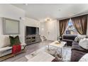 Comfortable living room showcasing a large TV, decorative mirror, and cozy seating area at 1631 Aspen Meadows Cir, Denver, CO 80260