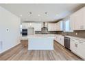 Modern kitchen with stainless appliances, large center island and an adjoining living space at 14107 Bunny Hop Ln, Parker, CO 80134