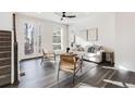 Inviting living area features sleek wood floors and a contemporary ceiling fan at 11487 W Grand Way, Littleton, CO 80127