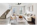 Bright living room with modern furnishings, stylish decor, and sun-drenched windows at 11487 W Grand Way, Littleton, CO 80127