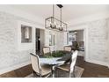 Elegant dining room with whitewashed brick and a farmhouse table at 319 13Th Ave, Idaho Springs, CO 80452