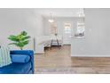 Open-concept kitchen with white breakfast nook table, and hardwood floors at 6000 Krameria St, Commerce City, CO 80022