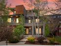 Contemporary home boasting stone accents, a landscaped yard, and a private balcony at 3841 Stuart St, Denver, CO 80212