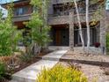 A modern home showing stone accents and lush landscaping, creating curb appeal at 3841 Stuart St, Denver, CO 80212