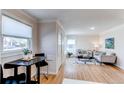 Open floorplan featuring a combined dining area and cozy living room with large windows at 1969 Uinta St, Denver, CO 80220