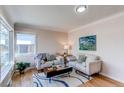 Cozy living room with hardwood floors, neutral paint, and natural light from a large window at 1969 Uinta St, Denver, CO 80220