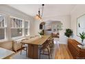 Elegant dining room with large windows, hardwood floors, and a modern chandelier, ideal for Gathering meals at 2636 N Glencoe St, Denver, CO 80207