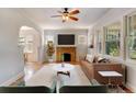 Bright living room with hardwood floors, a cozy fireplace, and ample natural light, perfect for entertaining at 2636 N Glencoe St, Denver, CO 80207