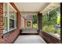 Inviting front porch features a comfortable swing, perfect for relaxing and enjoying the neighborhood views at 2636 N Glencoe St, Denver, CO 80207
