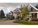 Beautiful home featuring a manicured lawn, and a covered front porch and stone accents add curb appeal at 5470 S Highline Cir, Greenwood Village, CO 80121
