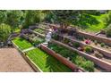 Aerial view of multi-tiered backyard with retaining walls, flowerbeds, and access stairs at 5425 Camargo Rd, Littleton, CO 80123