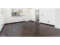 Bright bedroom featuring dark wood floors and multiple windows for ample natural light at 109 6Th St, Fort Lupton, CO 80621