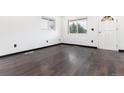 Spacious bedroom featuring rich dark wood floors and natural light from the windows at 109 6Th St, Fort Lupton, CO 80621