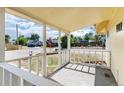 A quaint front porch with white railings overlooks a quiet street at 109 6Th St, Fort Lupton, CO 80621