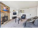 Living room features a stone fireplace and plenty of natural light at 4333 S Andes Way # 204, Aurora, CO 80015